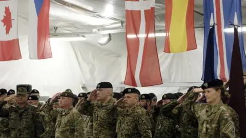 EPA-EFE Soldiers of the NATO's multinational EFP battlegroup in Latvia attend the ceremony at the Adazi Military base, Latvia, 03 July 202