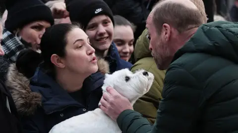 PA Media Prince William in Tallinn speaking to an onlooked who had brought her pet dog