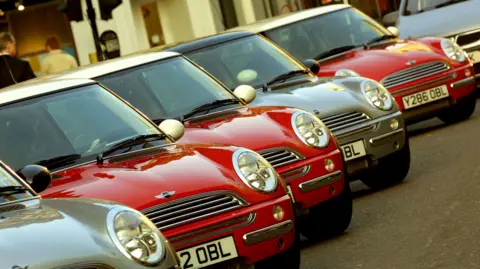 New Mini Cooper cars are parked in a row June 25 2001 in London, England as the new car was unveiled to the auto industry press. The Mini, a 42-year-old brand, is now manufactured by BMW Motors. 