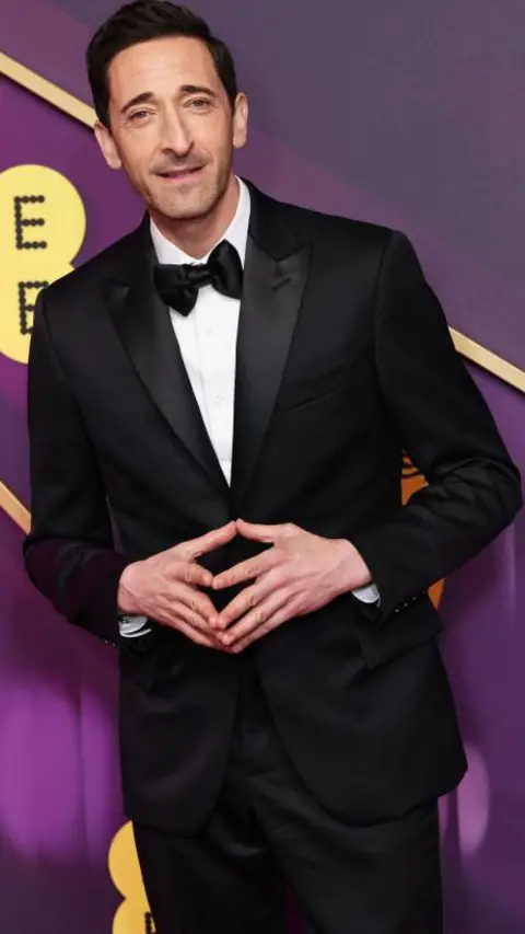 Getty Images Adrien Brody in a tuxedo black bow tie