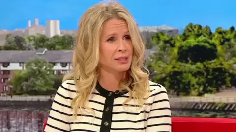 Lucy Beaumont in a pale yellow top with black stripes
