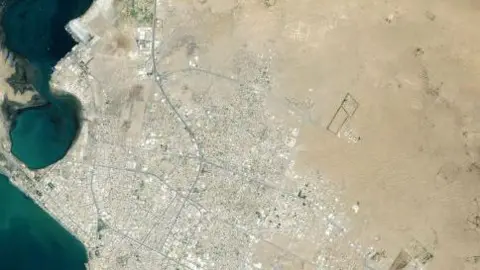 A satellite image shows the port city 
