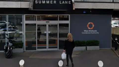 General view of the West Midlands Combined Authority's head office in Summer Lane in Birmingham. A woman dressed in black holding a white bag can be sen walking into a building