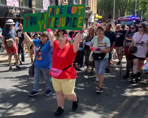 A woman holding up a sign reading "Pride not Prejudice" during the march at Notts Pride in Nottingham city centre on 25 July.