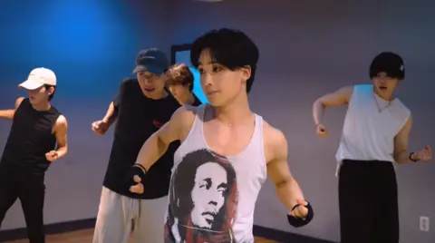 Singing Beetle Hyuk and other members during a dance training session