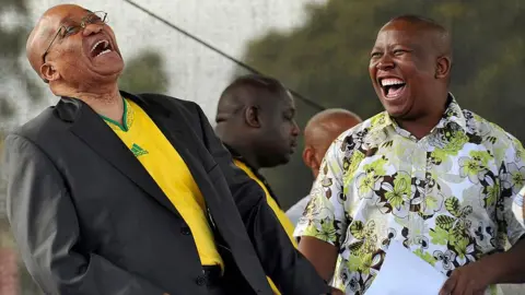 Getty Images Jacob Zuma dan Julius Malema berpidato di hadapan khalayak yang berkumpul dalam sebuah rapat umum untuk memperingati ulang tahun ke-66 Liga Pemuda ANC di sebuah stadion di Stellenbosch, Afrika Selatan - Oktober 2010