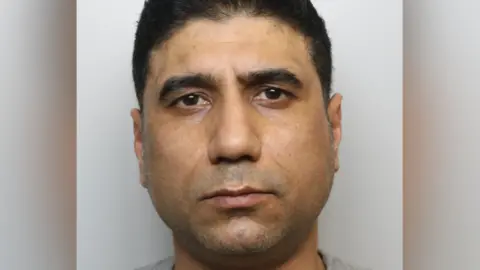 Thames Valley Police Najeebullah Arab mugshot. He has short dark hair and brown eyes.
