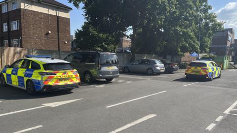 Police officers at the Dunstable Asda car park while trying to located the suspected offender