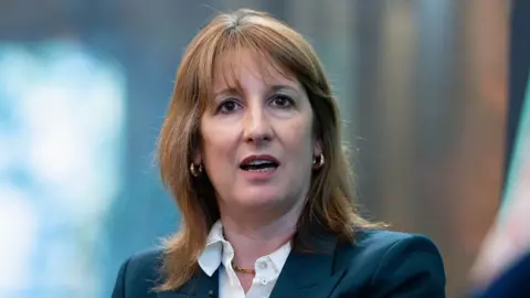 Thomas Krych/Anadolu via Getty Images UK Chancellor Rachel Reeves wearing a blue blazer and white blouse