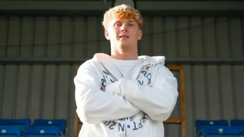 Sam Pearson poses for a photo while stood in Eastleigh's Silverlake Stadium