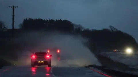 PA Images Water crashes over the wall on Portaferry Road in Newtownards, County Down. 