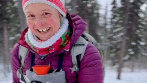 Pavlina cross country skiing with hot water bottle on her chest