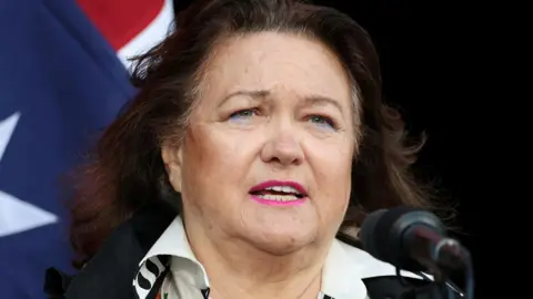 Gina Rinehart speaking at an Australia Day event in 2025, pictured with the Australian flag behind her