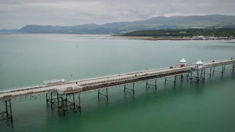 Marc Lock Photography Garth Pier, Bangor from above, with the blue-green sea beneath it
