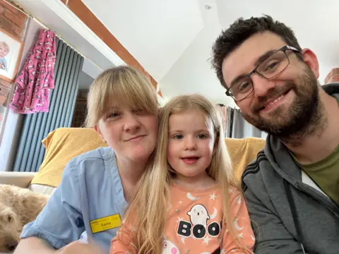 Timothy Cossa Timothy with his wife and daughter