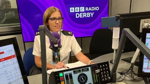 Supt Rebecca Webster, sitting in BBC Radio Derby's studio