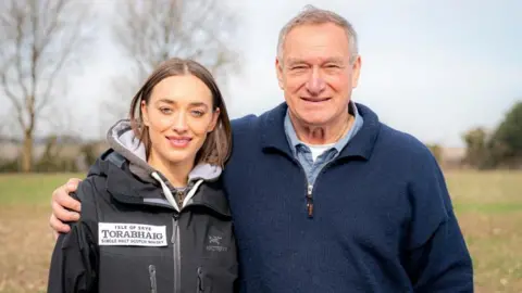 PA Media Camilla with her father David. They are both centre of the image and David has his arm around his daughter.