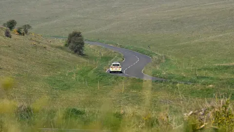 Getty Images: A police car drives near a bend in Beachy Head Road near Eastbourne