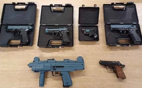 Nottinghamshire Police Six blank firing firearms laid out on a table, including four in plastic cases.