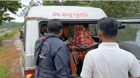 Las personas Samarendra Raut y Himansu Samal son evacuadas de las tierras bajas de Odisha