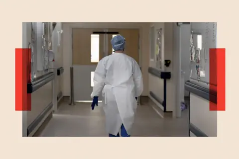 Getty Images A member of staff walks in the ICU ward corridor at a hospital 