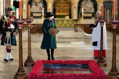 Getty Images Camilla, then Duchess of Cornwall, lays flowers as she visits the Grave of the Unknown Warrior at Westminster Abbey on 11 November 2021 