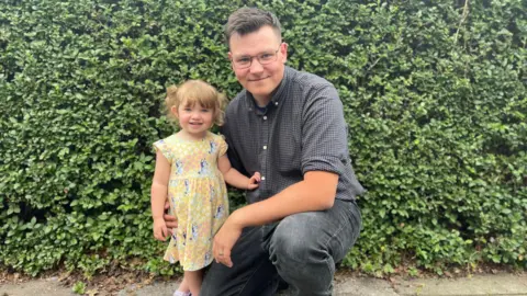 Supplied Connor pictured with his daughter, who is wearing a summer dress.