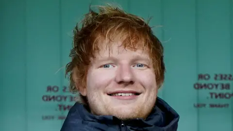 PA Media Singer Ed Sheeran during an Ipswich Town football match 