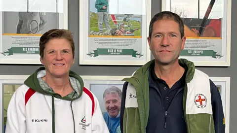 Team Guernsey Manager, Karina Jackson, and Chef de Mission, Peter Jory. Both are pictured wearing Team Guernsey branded kit. 