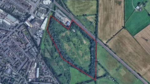 An aerial photograph of a field in Loughborough with a red line around it. 