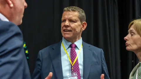 Getty Images Rhun ap Iorwerth, a man with short brown hair in a blue suit