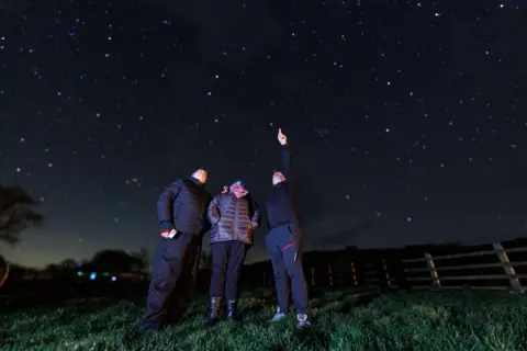 BBC/Thomas Winstone Dafydd Wyn Morgan guides James Harrison and Siân Harrison on star formations