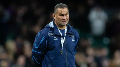 Pat Lam standing with his hands behind his back on the pitch during a pre-game warm-up with Bristol at the Principality Stadium