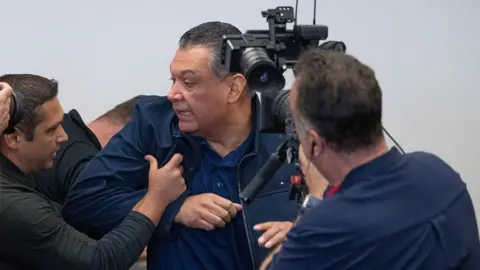 Officials push man out of room