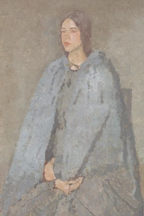 Yale Centre for British Art Oil painting of a young woman with light brown hair seated on a chair. She is wearing a blue dress and cloak and has her hands resting in her lap. She is looking towards the left of the painting.