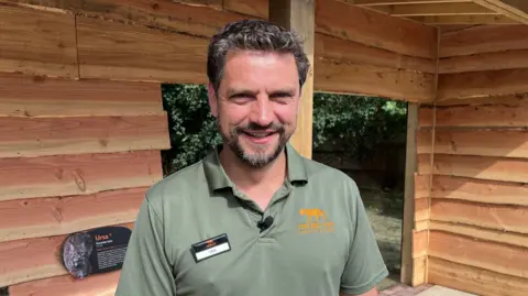 Ian Jones standing outside Ursa the Eurasian lynx's new habitat
