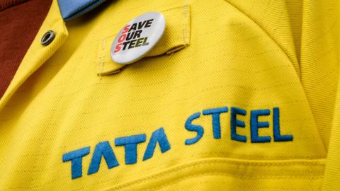 A steelworker bustin a Save our Steel badge