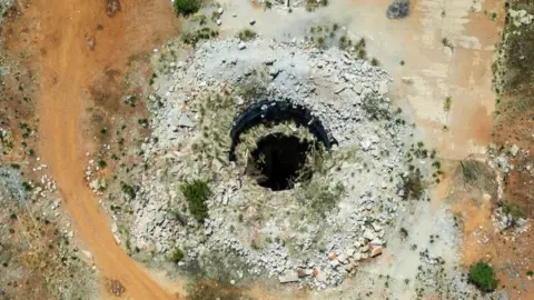 AFP An aerial view shows an open mine shaft in Stilfontein