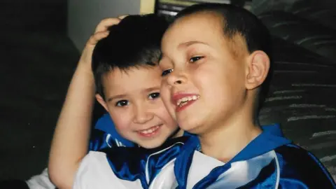 Murray family Matt and Jamie Murray pictured as children while hugging and wearing matching blue and white Colchester United tops.