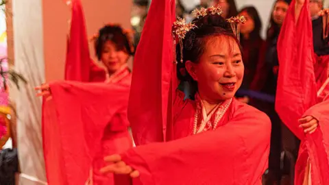 Manchester Museum Dancers dressed in red traditional Chinese clothes perform a dance as part of Chinese New Year celebrations at Manchester Museum.