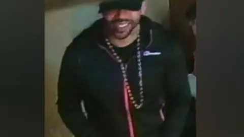 Nottinghamshire Police Image of a man in dark clothing and wearing a black baseball cap
