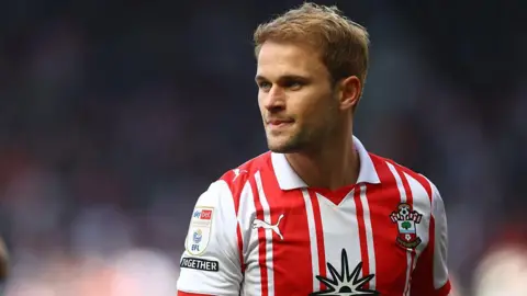 Leo Scienza wearing his red and white Southampton shirt