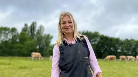 Harriet Cowan standing on her farm in Derbyshire