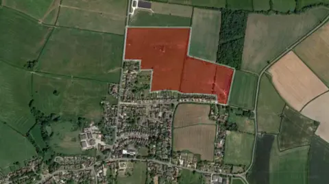 Google A Google maps image of Marsh Gibbon, a medium-sized village with fields surrounding it. A red shaded area on the northern edge of the housing indicates where new homes would be built.