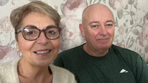 Marie-José and Paul Watkins look at the camera