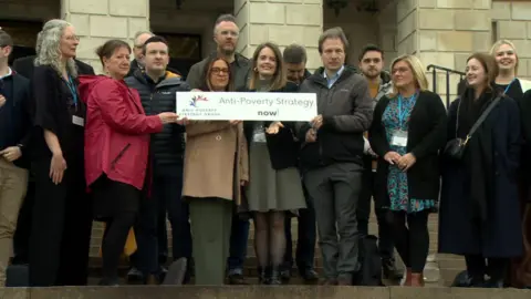 Anti-poverty campaigners on the steps outside Sormont.