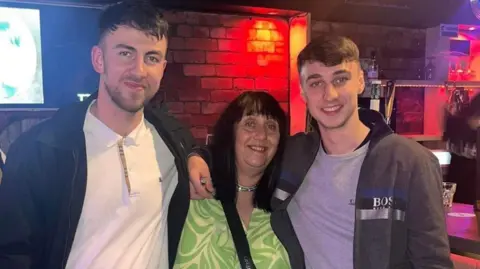 Handout Zak Slater and Jay Slater stand either side of their mother, Debbie Duncan