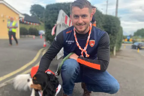 A man and his dog celebrate. 