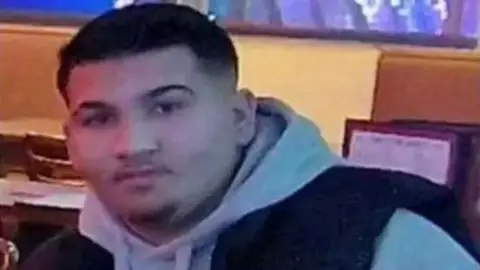 Family handout A teenage man with dark hair and stubble. He is wearing a grey hoodie and what appears to be a black gilet on top.