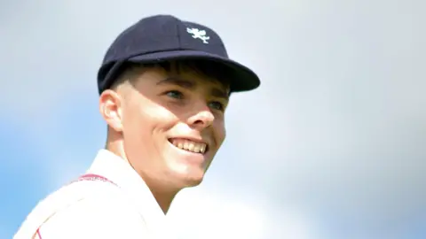 Archie Vaughan smiles while playing for Somerset